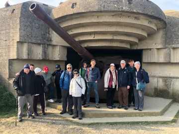 Guns at Normandy Beach with a Small Group of Travelers